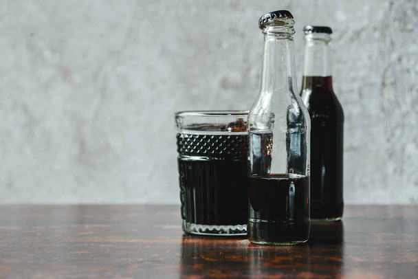 selective focus of cold brew coffee in bottles and glass - Фото, изображение