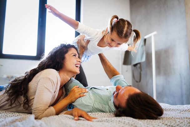 Happy young family having fun times at home - Фото, изображение