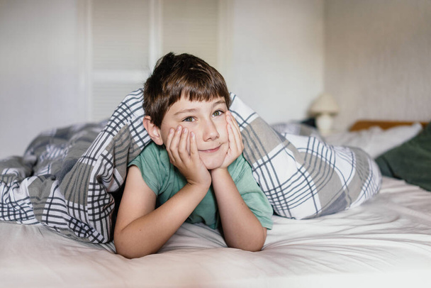 Portrait of a boy on a bed in bedroom  - Foto, Bild