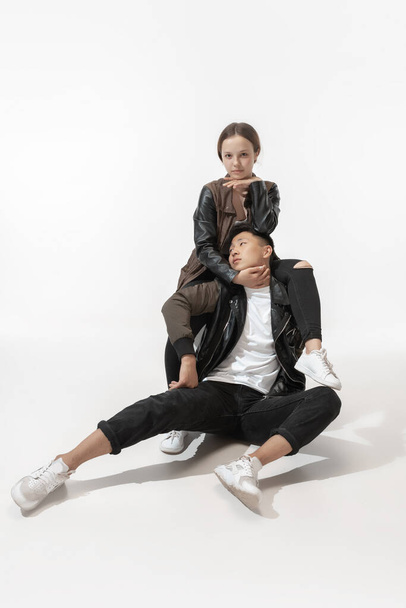 Trendy fashionable couple isolated on white studio background - Φωτογραφία, εικόνα