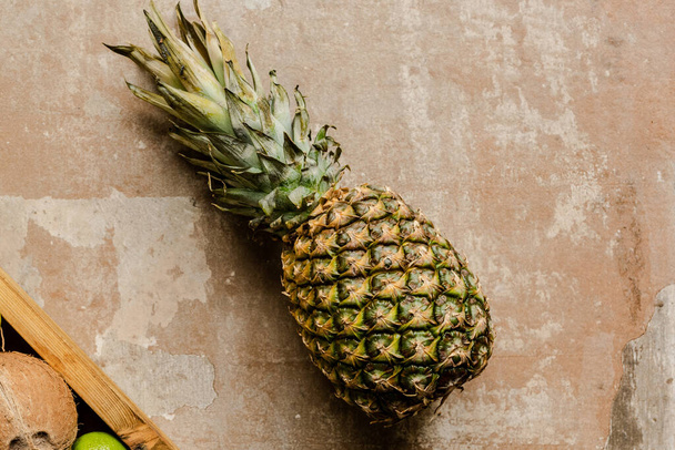 top view of ripe pineapple on weathered surface - Foto, Imagen