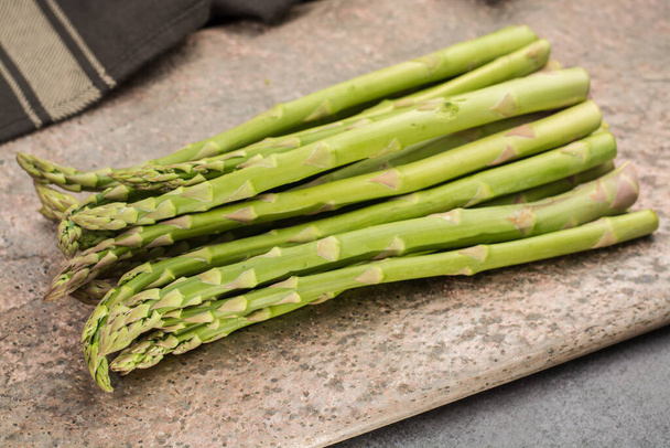 Bunch of uncooked green asparagus, tasty vegetarian food - Photo, Image