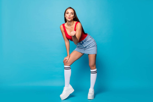 Full length photo of charming romance trendy girl lady hold hand send air kiss her boyfriend attract ideal perfect guy wear legs red tank-top white singlet isolated over blue color background - Foto, Imagem