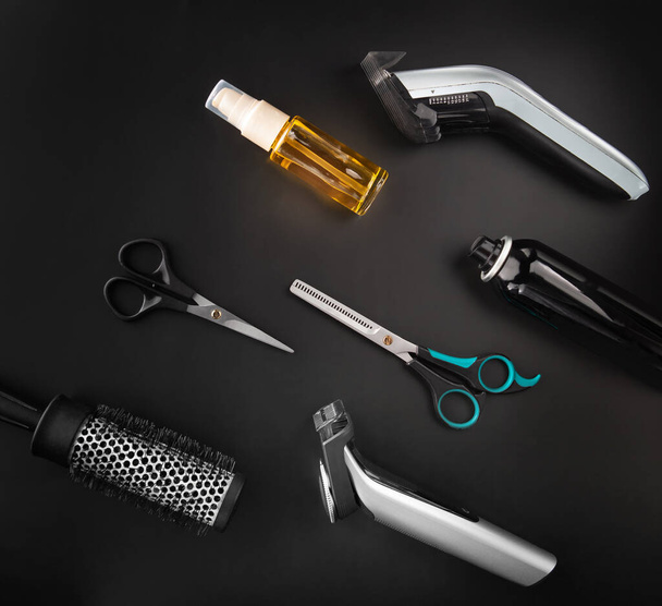 Barber tools for cutting and styling on a black background. - Foto, Bild