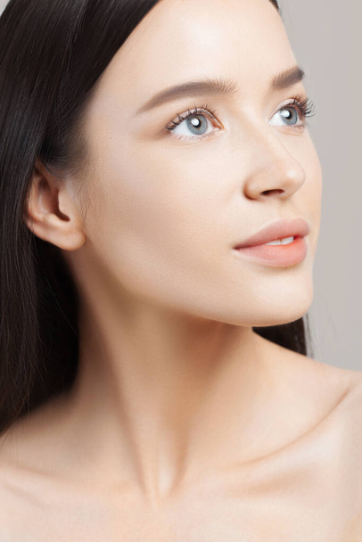 Young beautiful woman with clean perfect skin closeup. Beauty and skin care - 写真・画像