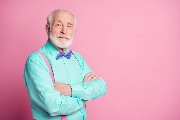 Photo of amazing stylish look grandpa hands crossed seriously facial expression wear mint shirt suspenders violet bow tie isolated bright pink color background - Photo, image