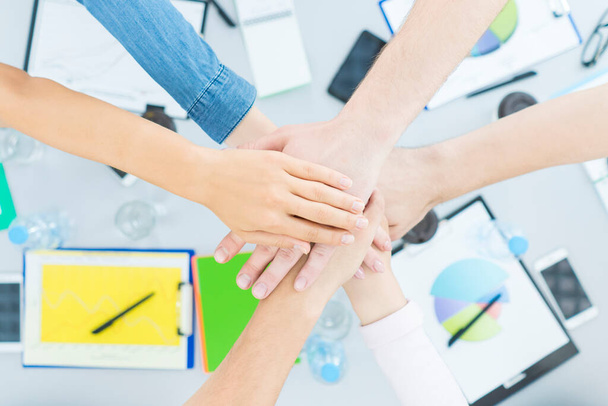 The six people hold hands at the desktop. view from above - Photo, Image