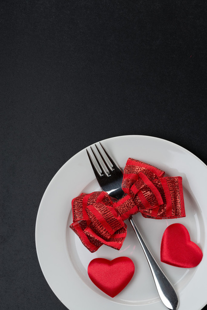 Festive table setting for Valentine's Day on a black background - Zdjęcie, obraz