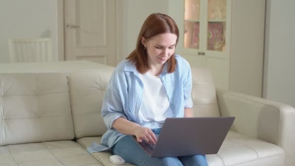 woman using laptop, typing text, sitting on sofa. sick and coughing - Filmagem, Vídeo