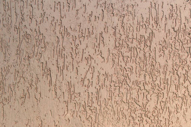 texturált vakolat halvány rózsaszín szín a falon - Fotó, kép