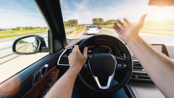 angry car driver on steering wheel,  road trip, driving on highway road - Φωτογραφία, εικόνα