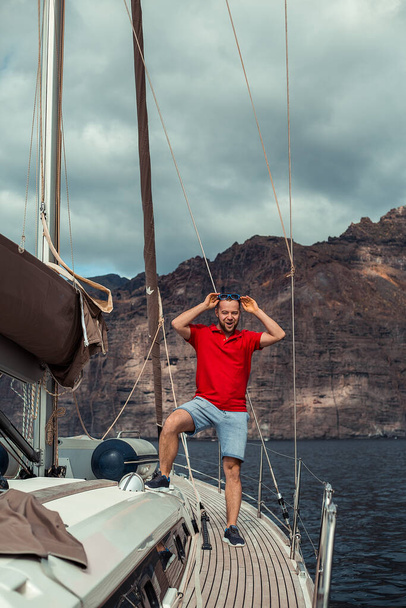 Happy bearded man resting on yacht at sunny day - Photo, Image