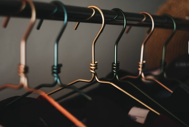 Metal clothes hanger, warm light, close-up. - Foto, afbeelding
