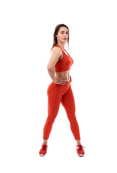 Young athletic woman posing as fitness model on white background - Photo, image