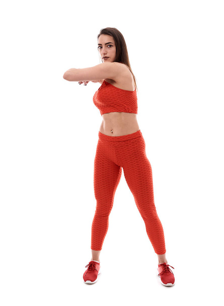 Young athletic woman posing as fitness model on white background - Foto, afbeelding