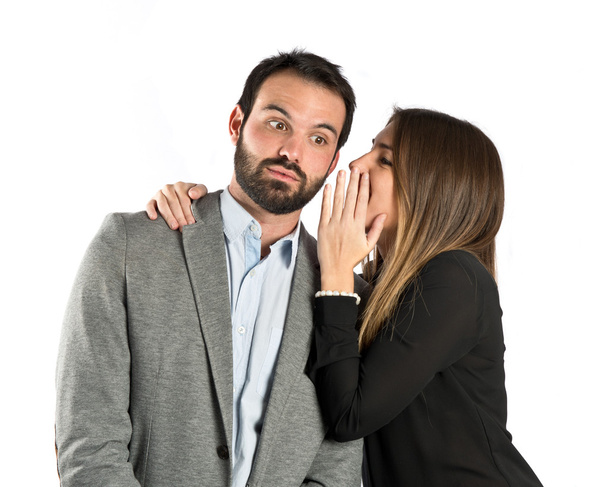 young girl whispering to her boyfriend over white background - Foto, Imagem