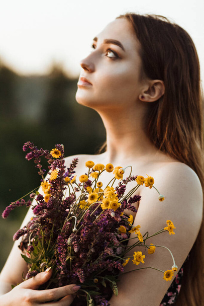 beautiful girl with bouquet of wildflowers on meadow, young woman with long hair on nature,summer tender photo in village, style and fashion - Fotoğraf, Görsel