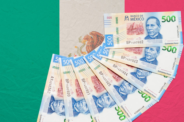 Мексиканські гроші на вершині мексиканського прапора. - Фото, зображення