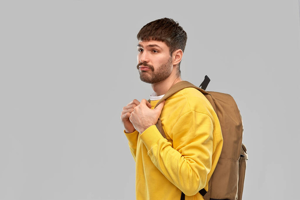 sad unhappy young man with backpack - Фото, зображення