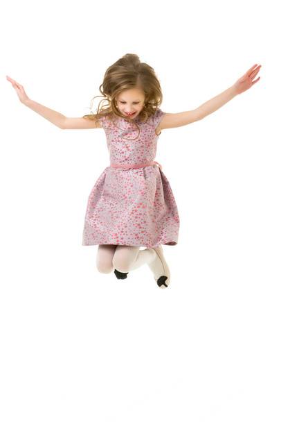 Beautiful Blonde Girl Happily Jumping with Raising Hands - Photo, image