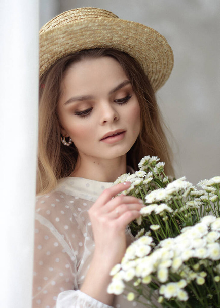 beautiful gentle girl in a bright interior with flowers spring summer fresh image - Photo, image