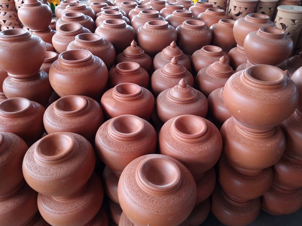 open air workshop of ceramics, earthenware, orange and brown terracotta flower pots craftmanship in Thailand - Photo, Image
