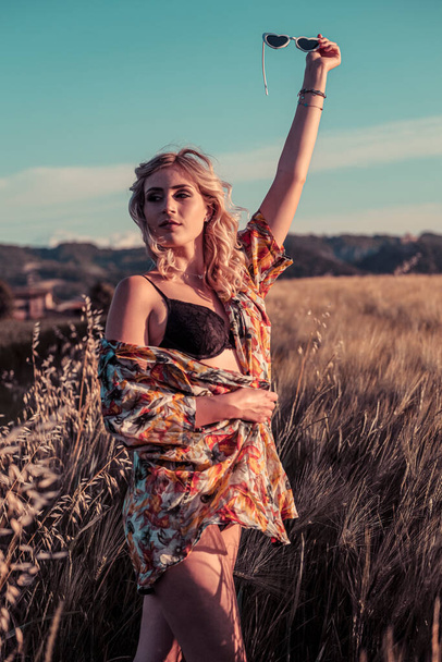 beautiful blonde girl posing in wheat field in underwear and sunglasses. High quality photo - Valokuva, kuva