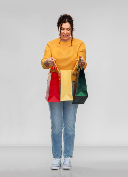 happy smiling young woman with shopping bags - Фото, зображення
