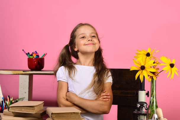 Kid and school supplies on pink wall background - Foto, immagini