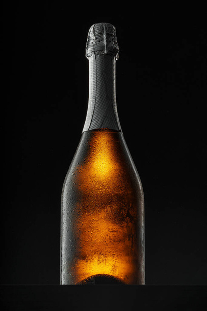 Champagne bottle on black background, copy space - Foto, immagini