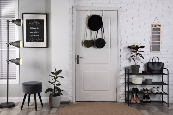 Hallway interior with stylish furniture, shoes and plants - Photo, Image