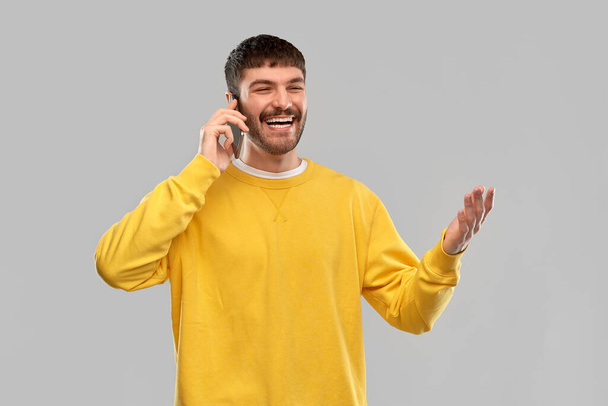 heureux jeune homme souriant appelant sur smartphone - Photo, image