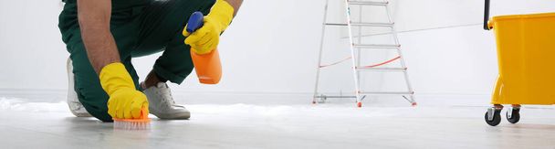 Professional janitor cleaning floor with brush and detergent, closeup view. Banner design - Фото, изображение