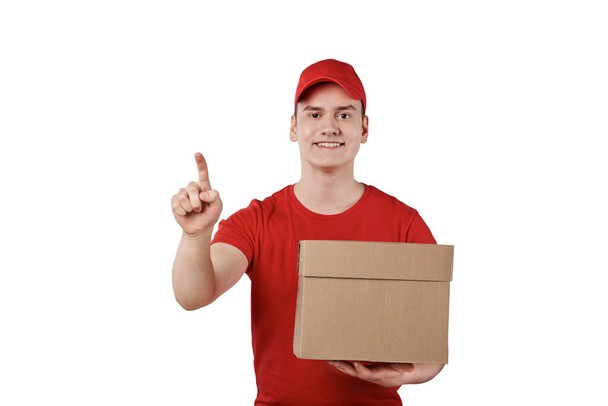 A guy in a special uniform of red knocks on the door with a parcel in his hand. - 写真・画像