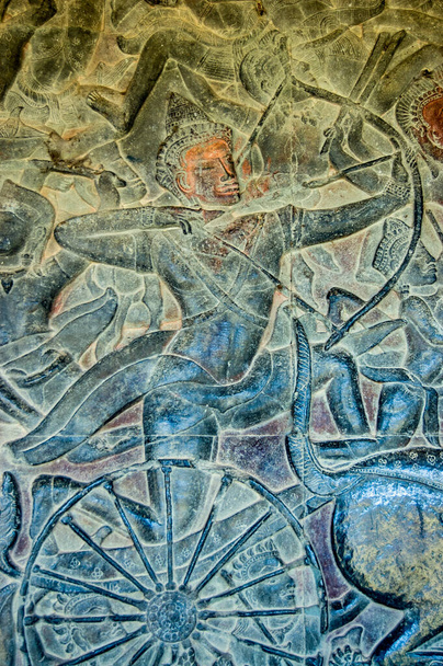 Bas relief sculpture on a wall of Angkor Wat temple, Siem Reap, Cambodia. An archer is shown in battle riding on a chariot fighting in the Battle of Kurukshetra as described in the Mahabharata. - Photo, Image