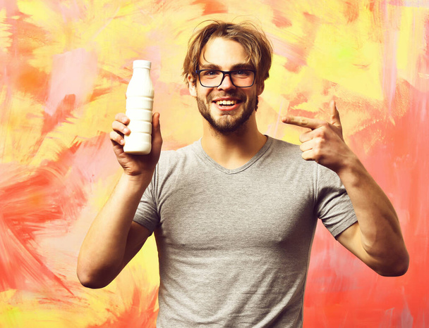 Caucasian bearded sexy macho man holding bottle of milk - Фото, изображение