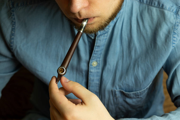 Ritual tobacco smoking concept. Male with smoking pipe - Фото, изображение