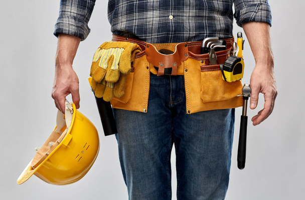 worker or builder with helmet and working tools - Foto, Imagen
