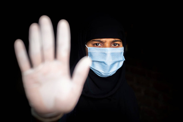 Stop coronavirus. A young Asian woman wearing a face mask and medical rubber gloves. Protest and Focus shifted photo. - Zdjęcie, obraz