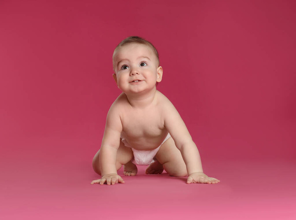 Cute little baby in diaper on pink background - Фото, зображення