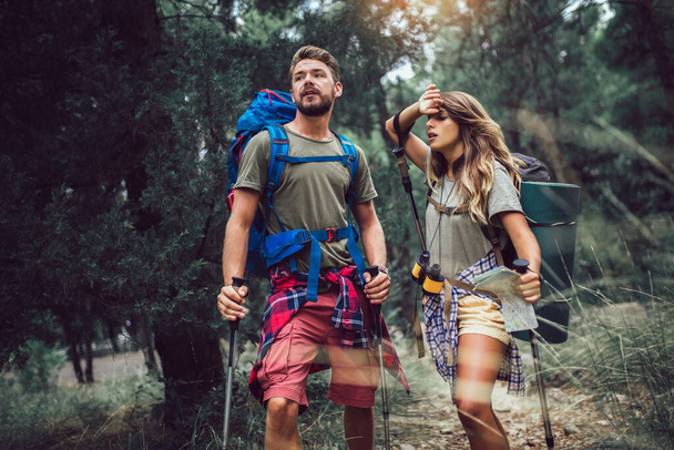 Happy young couple hiking together. - Photo, Image