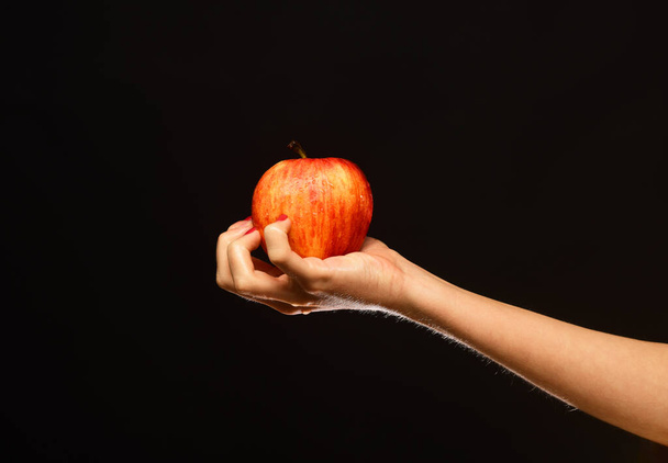 Farming and healthy nutrition concept. Female hand holds fresh fruit - Foto, Imagem