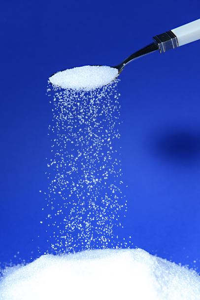 Sugar on blue background - Foto, imagen