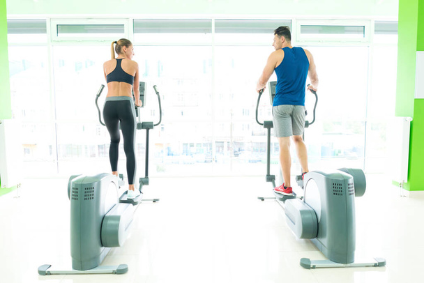 The sport couple in the cardio apparatus - Photo, Image