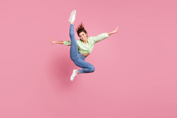 Full length body size view of her she nice attractive slender energetic cheerful cheery girl jumping making doing pirouette exercise having fun practicing isolated over pink pastel color background - Фото, зображення