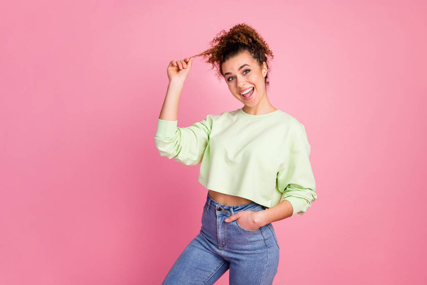 Portrait of her she nice-looking attractive lovely pretty glad funky girlish cheerful cherry girl pulling curl hairstyle having fun isolated over pink pastel color background - Foto, Bild