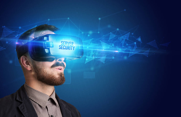 Businessman looking through Virtual Reality glasses, virtual security concept - Zdjęcie, obraz