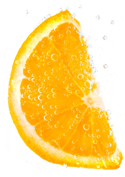Orange in water with bubbles isolated on white - 写真・画像