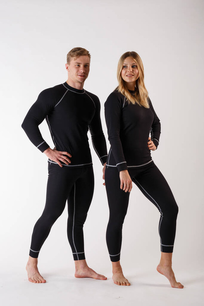 Guy and girl in thermal underwear on a white background - Photo, Image