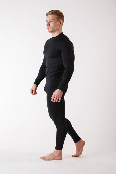 The guy in thermal underwear on a white background. Sportswear. - Foto, afbeelding
